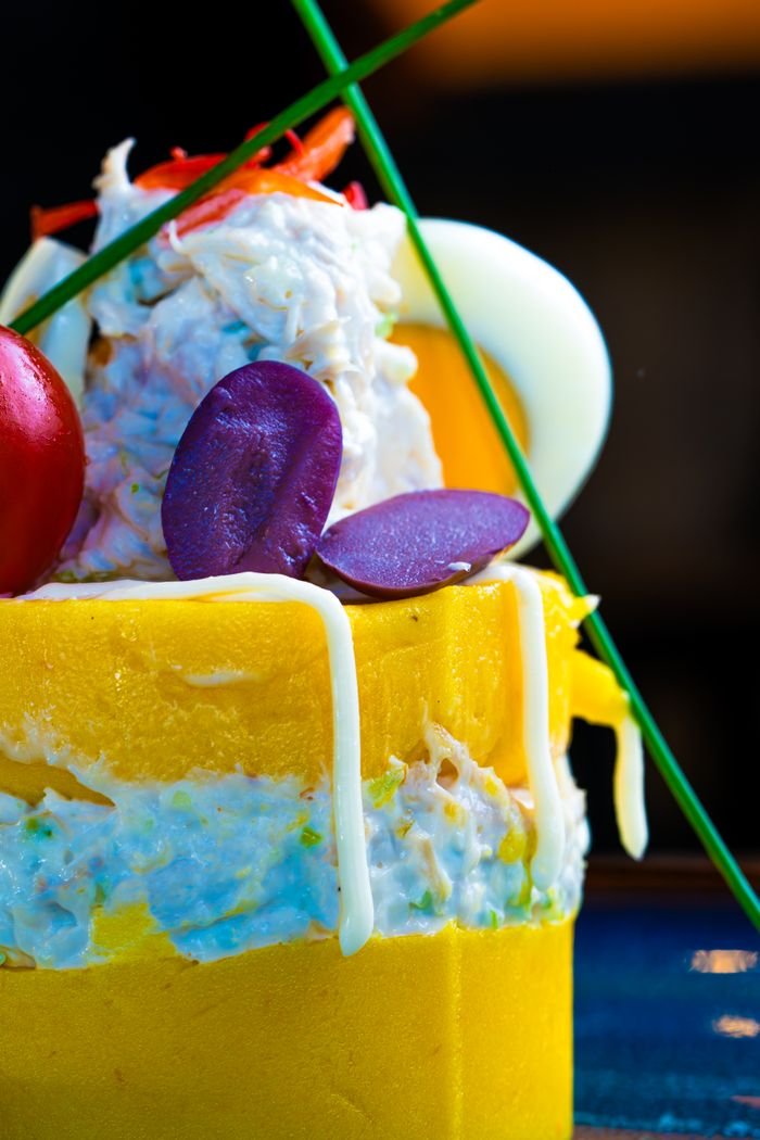 A vibrant gourmet dish with layered ingredients and artistic presentation.