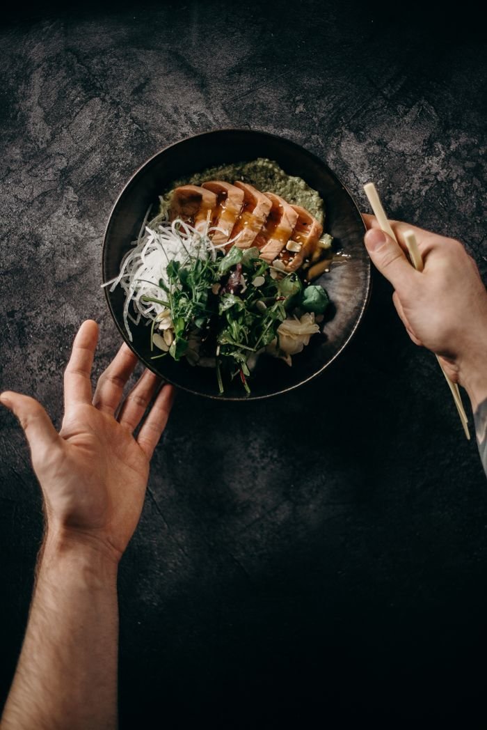 A delicious Asian salmon dish with greens and noodles, captured in a flat lay style.